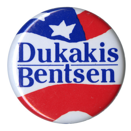 Round button with red, white, and blue stars and stripes decorations and blue text reading "Dukakis Bentsen"