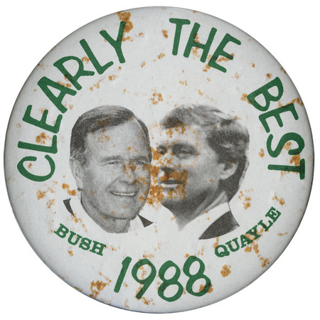 Round, white button with black and white photographs of George H. W. Bush and Dan Quayle. Black text reads "CLEARLY THE BEST BUSH QUAYLE 1988"