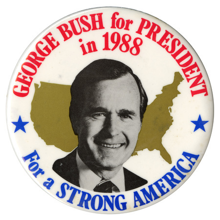 Round, white button with a black and white photograph of George H. W. Bush against a gold outline of the United States. Red and blue text reads "GEORGE BUSH for PRESIDENT in 1988 For a STRONG AMERICA"