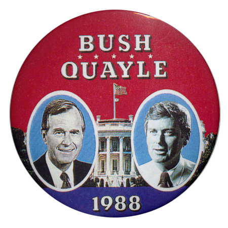 Round, red button with black and white photographs of George H. W. Bush and Dan Quayle against a photograph of the White House. White text reads "BUSH QUAYLE 1988"