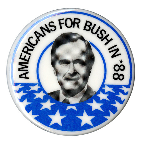 Round button with a border of white stars on a blue field and a black and white photograph of George H. W. Bush in the center. Black text reads "AMERICANS FOR BUSH IN '88"