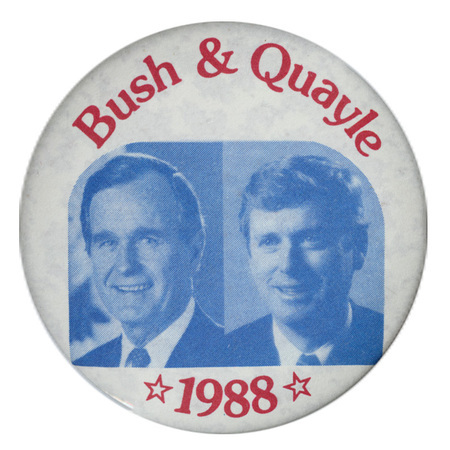 Round, white button with blue and white photographs of George H. W. Bush and Dan Quayle. Red text reads "Bush & Quayle 1988"