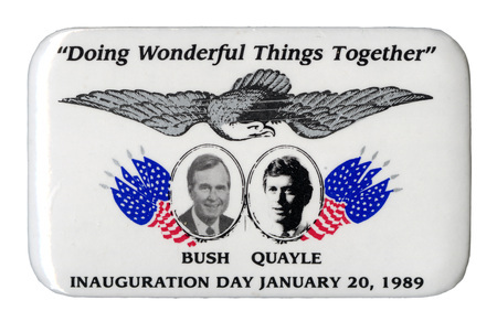 Rectangular, white button with black and white photographs of George H. W. Bush and Dan Quayle, each with his last name below his photograph, surrounded by US flags and an eagle drawing. Black text reads ""Doing Wonderful Things Together" INAUGURATION DAY JANUARY 20, 1989"
