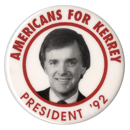 Round, white button with a black and white photograph of Bob Kerrey within a red circle, Red text reads "AMERICANS FOR KERREY PRESIDENT '92"