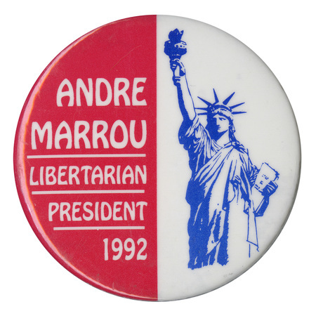 Round button with a red left half with white text reading "ANDRE MARROU LIBERTARIAN PRESIDENT 1992." The right half is white and contains a blue drawing of the Statue of Liberty.