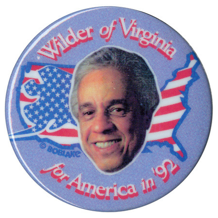 Round, blue button with a color photograph of Lawrence Douglas Wilder against an outline of the United States filled with the red, white, and blue stars and stripes of the US flag. White and red text reads "Wilder of Virginia for America in '92"