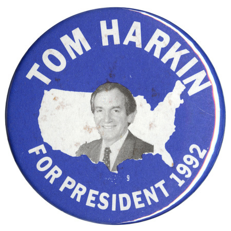 Round, blue button with a black and white photograph of Tom Harkin against a white outline of the United States. White text reads "TOM HARKIN FOR PRESIDENT 1992"