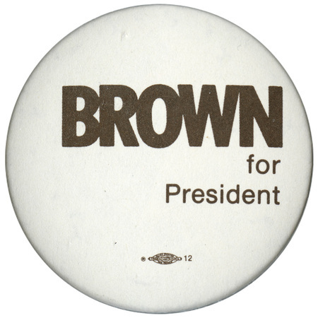 Round, white button with dark brown text reading "BROWN for President"