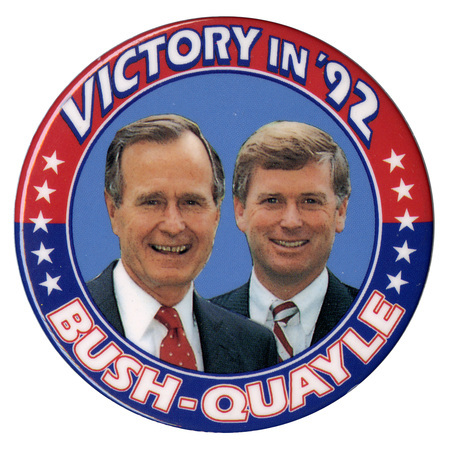 Round button with a red and blue border and color photographs of George H. W. Bush and Dan Quayle in the center. White text around the edge of the button reads "VICTORY IN '92 BUSH-QUAYLE"