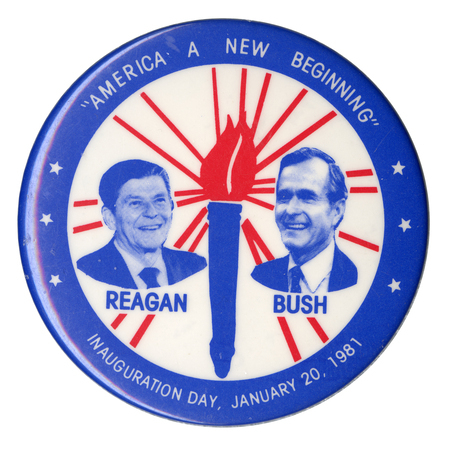 Round button with a blue border. Within a white circle in the center are photographs of Ronald Reagan and George H. W. Bush on either side of a blue and red drawing of a torch emitting beams of light. White and blue text reads ""AMERICA A NEW BEGINNING REAGAN BUSH INAUGURATION DAY, JANUARY 20, 1981"