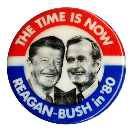 Round button with red and blue border and black and white photographs of Ronald Reagan and George H. W. Bush in the center. White text reads "THE TIME IS NOW REAGAN-BUSH in '80"