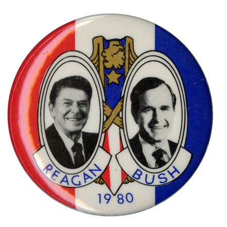Round button with bands of red, white, and blue. Black and white photographs of Ronald Reagan and George H. W. Bush appear in the center. Blue text reads "REAGAN BUSH 1980"