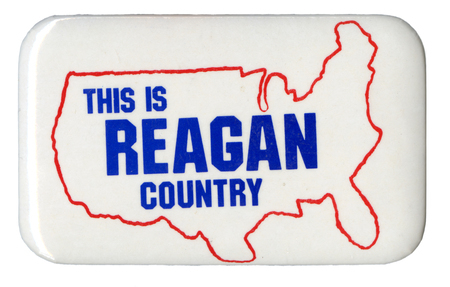 Rectangular, white button with a red outline of the United States and blue text reading "THIS IS REAGAN COUNTRY"