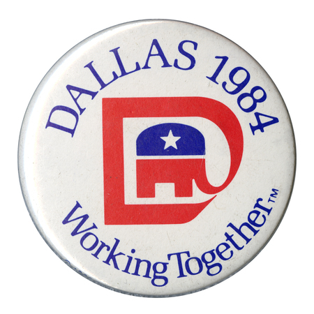Round, white button with the GOP elephant symbol whose trunk is extended into a "D" shape. Blue text reads "DALLAS 1984 Working Together TM"