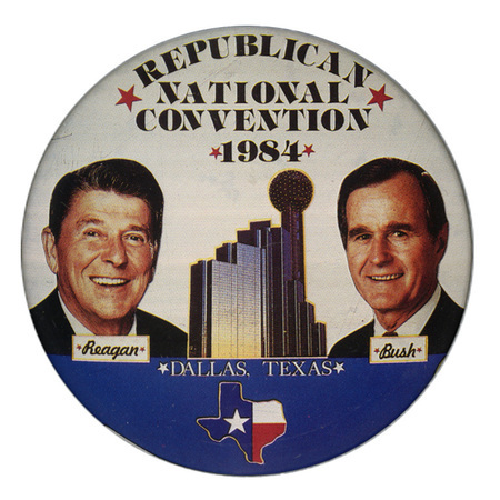 Round button with color photographs of Ronald Reagan and George H. W. Bush on either side of a color photograph of the Hyatt Regency Hotel and Reunion Tower in Dallas, Texas. An outline of the state of Texas filled with the Texas state flag design appears below. Black and white text reads "REPUBLICAN NATIONAL CONVENTION 1984 Reagan Bush DALLAS, TEXAS"