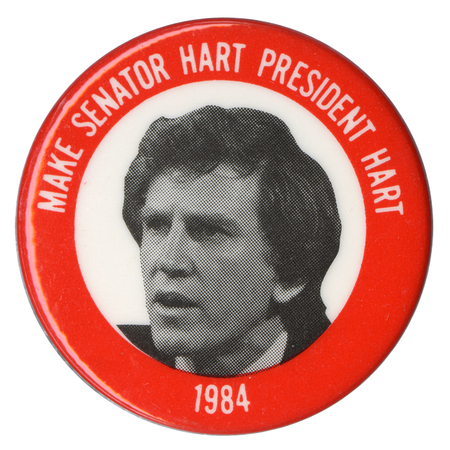 Round button with a red border and a black and white photograph of Gary Hart in a white circle in the center. White text reads "MAKE SENATOR HART PRESIDENT HART 1984"