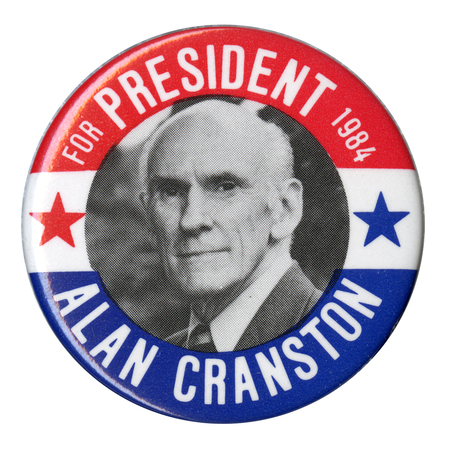 Round button with bands of red, white, and blue and a black and white photograph of Alan Cranston between red and blue stars. White text reads "FOR PRESIDENT 1984 ALAN CRANSTON"