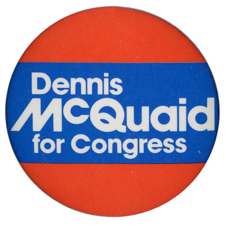 Round, red and blue button with white text reading "Dennis McQuaid for Congress"
