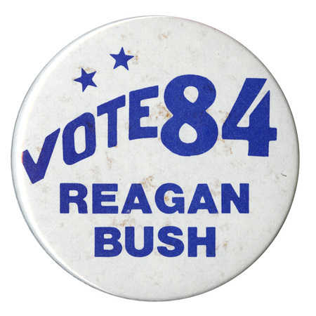 Round, white button with blue text reading "VOTE 84 REAGAN BUSH"