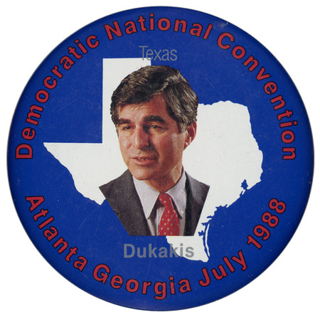 Round, blue button with a color photograph of Michael Dukakis against a white outline of the state of Texas.