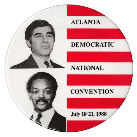 Round, red and white striped button with black and white photographs of Michael Dukakis and Jesse Jackson. Red text reads "ATLANTA DEMOCRATIC NATIONAL CONVENTION July 18-21, 1988"