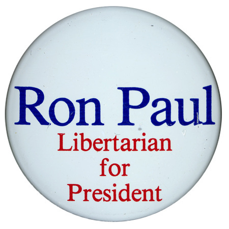 Round, white button with blue and red text reading "Ron Paul Libertarian for President"