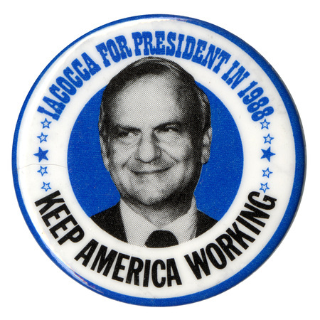 Round button with a white border and a black and white photograph of Lee Iacocca in a blue circle in the center. Blue and black text reads "IACOCCA FOR PRESIDENT IN 1988 KEEP AMERICA WORKING"