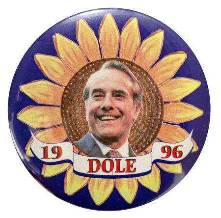 Round, blue button with a large color illustration of a sunflower. In the center is a color photograph of Bob Dole. Red text reads "DOLE 1996"