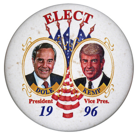 Round, white text with color images of Bob Dole and Jack Kemp in gold frames on either side of a group of 5 US flags. Red and blue text reads "ELECT DOLE President KEMP Vice Pres. 1996"