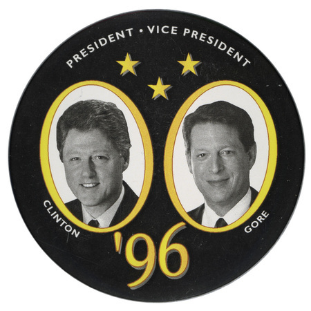 Round, black button with black and white photographs of Bill Clinton and Al Gore in yellow frames. White and yellow text reads "PRESIDENT VICE PRESIDENT CLINTON GORE '96"