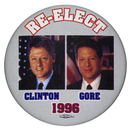 Round, gray button with color photographs of Bill Clinton and Al Gore. White, blue and red text reads "RE-ELECT CLINTON GORE 1996"