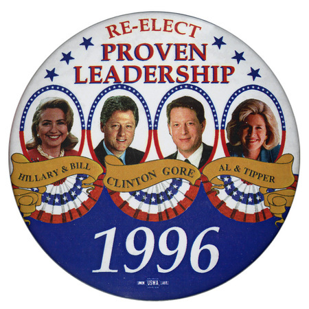 Round, white and blue button with color photographs of Hillary Clinton, Bill Clinton, Al Gore, and Tipper Gore set in circles. Red, blue, and white text reads "RE-ELECT PROVEN LEADERSHIP HILLARY & BILL CLINTON GORE AL & TIPPER 1996"