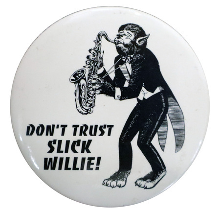 Round, white button with a black and white illustration of a werewolf in a tuxedo playing a saxophone. Black text reads "DON'T TRUST SLICK WILLIE!"
