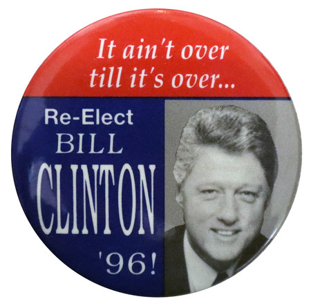 Round button with sections of red, blue, and a black and white photograph of Bill Clinton. White text reads "It ain't over till it's over...Re-Elect BILL CLINTON '96!"