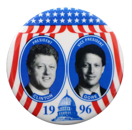 Round button with red, white, and blue stars and stripes and a blue illustration of the US Capitol. Black and white photographs of Bill Clinton and Al Gore appear in blue circles. White and blue text reads "PRESIDENT CLINTON VICE PRESIDENT AL GORE 1996"