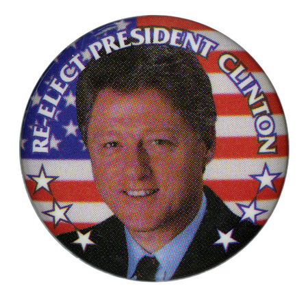 Round button with a color photograph of Bill Clinton against a US flag. White text around the edge of the button reads "RE-ELECT PRESIDENT CLINTON"