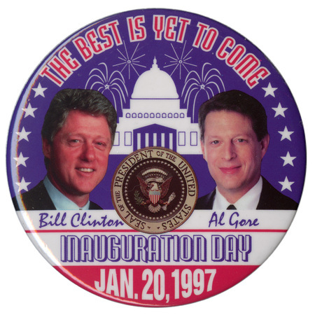 Round button with color photographs of Bill Clinton and Al Gore, the presidential seal, and a blue and white illustration of the US Capitol surrounded by fireworks explosions and white stars. Red, white, and blue text reads "THE BEST IS YET TO COME Bill Clinton Al Gore INAUGURATION DAY JAN. 20, 1997"