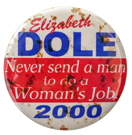 Round, white button with a band of red across the center. Red, blue, and white text reads "Elizabeth DOLE Never send a man to do a Woman's Job. 2000"