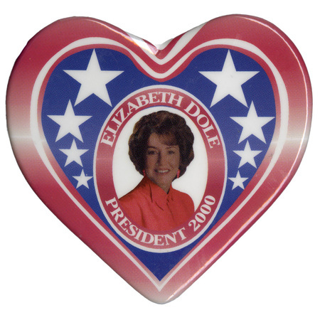 Heart-shaped button with a red and white striped border around a section of blue with white stars. In the center is a color photograph of Elizabeth Dole. White text reads "ELIZABETH DOLE PRESIDENT 2000"