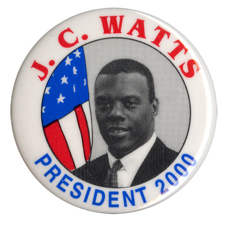 Round, white button with a black and white photograph of J. C. Watts and a color illustration of the US flag. Red and blue text reads "J. C. WATTS PRESIDENT 2000"