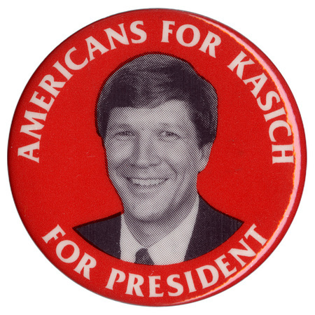 Round, red button with a black and white photograph of John Kasich in the center. White text reads "AMERICANS FOR KASICH FOR PRESIDENT"
