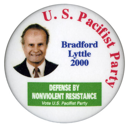 Round, white button with a color photograph of Bradford Lyttle. Red and blue text reads "U. S. Pacifist Party Bradford Lyttle 2000". In a green patch near the bottom of the button is white text reading "DEFENSE BY NONVIOLENT RESISTANCE Vote U.S. Pacifist Party"