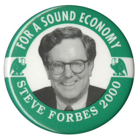 Round button with a green border and white center. A black and white photograph of Steve Forbes is flanked by green and white illustrations of eagles. White text reads "FOR A SOUND ECONOMY STEVE FORBES 2000"
