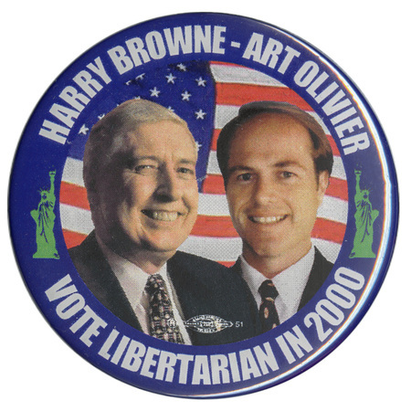 Round button with a blue border that includes green illustrations of the Statue of Liberty. In the center are color photographs of Harry Browne and Art Olivier against an image of the US flag. White text reads "HARRY BROWN-ART OLIVIER VOTE LIBERTARIAN IN 2000"