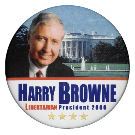 Round button with an upper section containing a color photograph of Harry Browne against a color photograph of the White House. The lower section has a white background and blue and red text reading "HARRY BROWNE LIBERTARIAN President 2000"