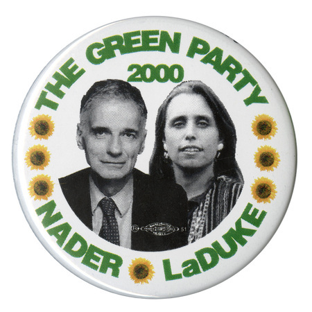 Round, white button with black and white photographs of Ralph Nader and Winona LaDuke and seven color photographs of sunflowers. Green text reads "THE GREEN PARTY 2000 NADER LaDUKE"