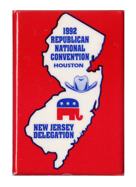 Rectangular, red button with a white outline of the state of New Jersey containing a drawing of a hat, the GOP elephant symbol, and blue text reading "1992 REPUBLICAN NATIONAL CONVENTION HOUSTON NEW JERSEY DELEGATION"