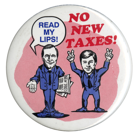 Round, white button with cartoon drawings of George H. W. Bush and Dan Quayle, who is forming peace signs with each hand. A speech bubble above Bush's head has blue text reading "READ MY LIPS!" Red text reads "NO NEW TAXES!"