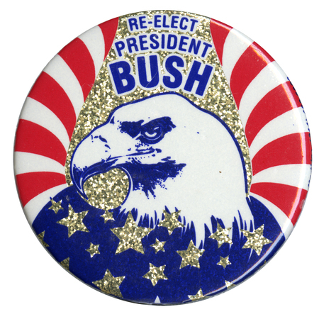 Round button with a drawing of the head of an eagle emerging from a red, white, and blue US flag against a glittery gold background. White and blue text reads "RE-ELECT PRESIDENT BUSH" 