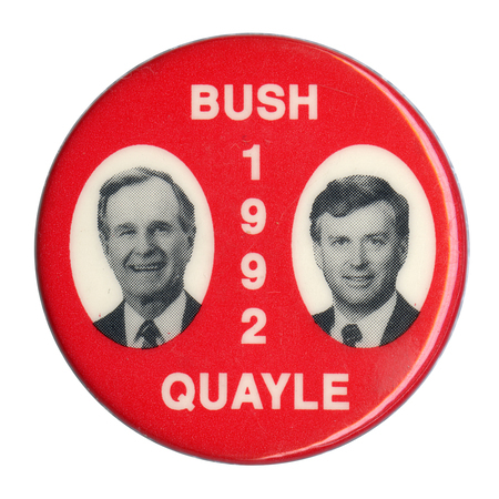 Round, red button with black and white photographs of George H. W. Bush and Dan Quayle. White text reads "BUSH 1992 QUAYLE"